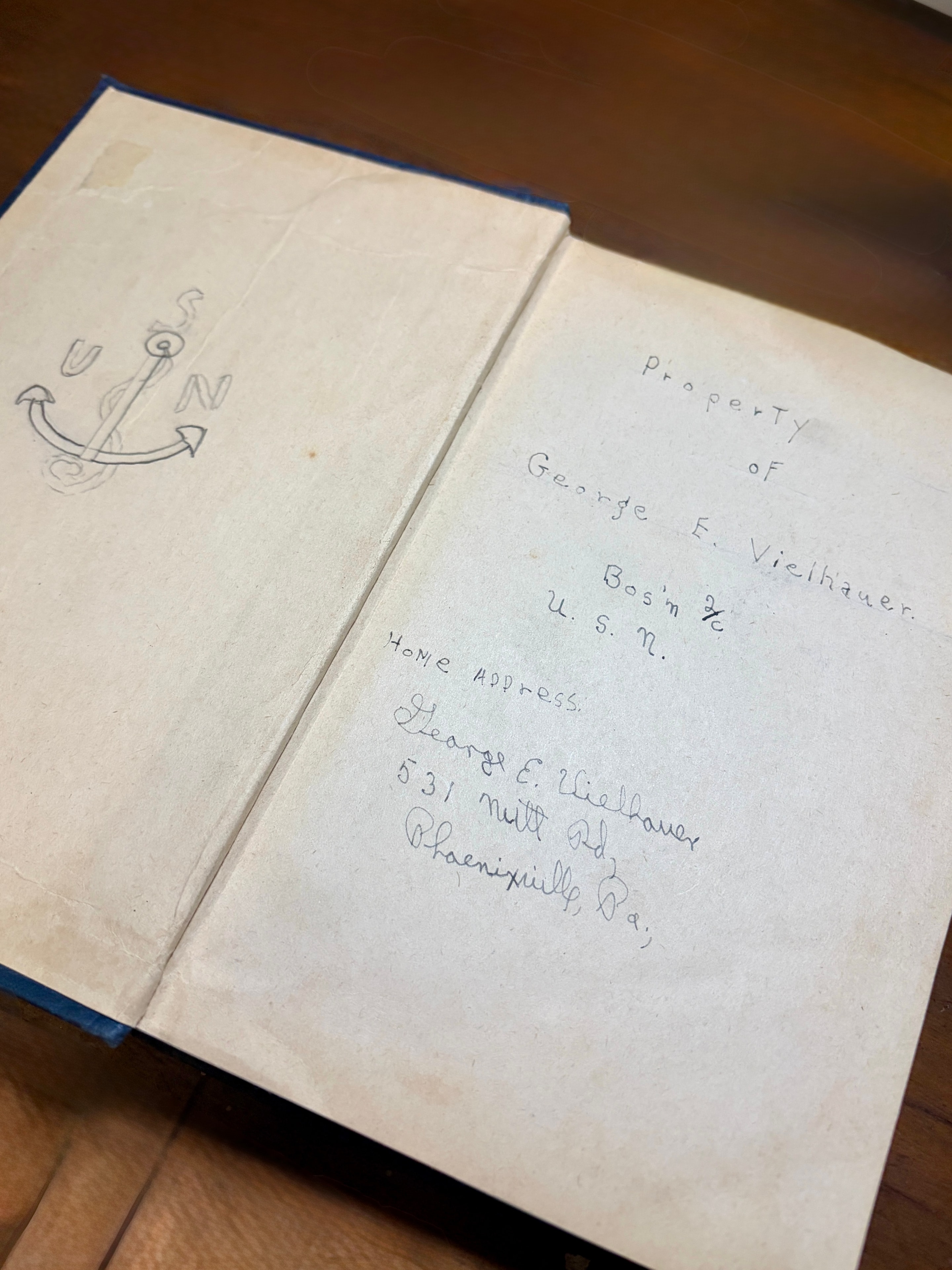 Inside cover of George Vielhauer's Bluejackets' Manual — handwritten inscription reading 'Property of George E. Vielhauer, Bos'n 2/c, U.S.N.' with his address at 531 Nutt Rd, Phoenixville, Pa., and a hand-drawn USN anchor